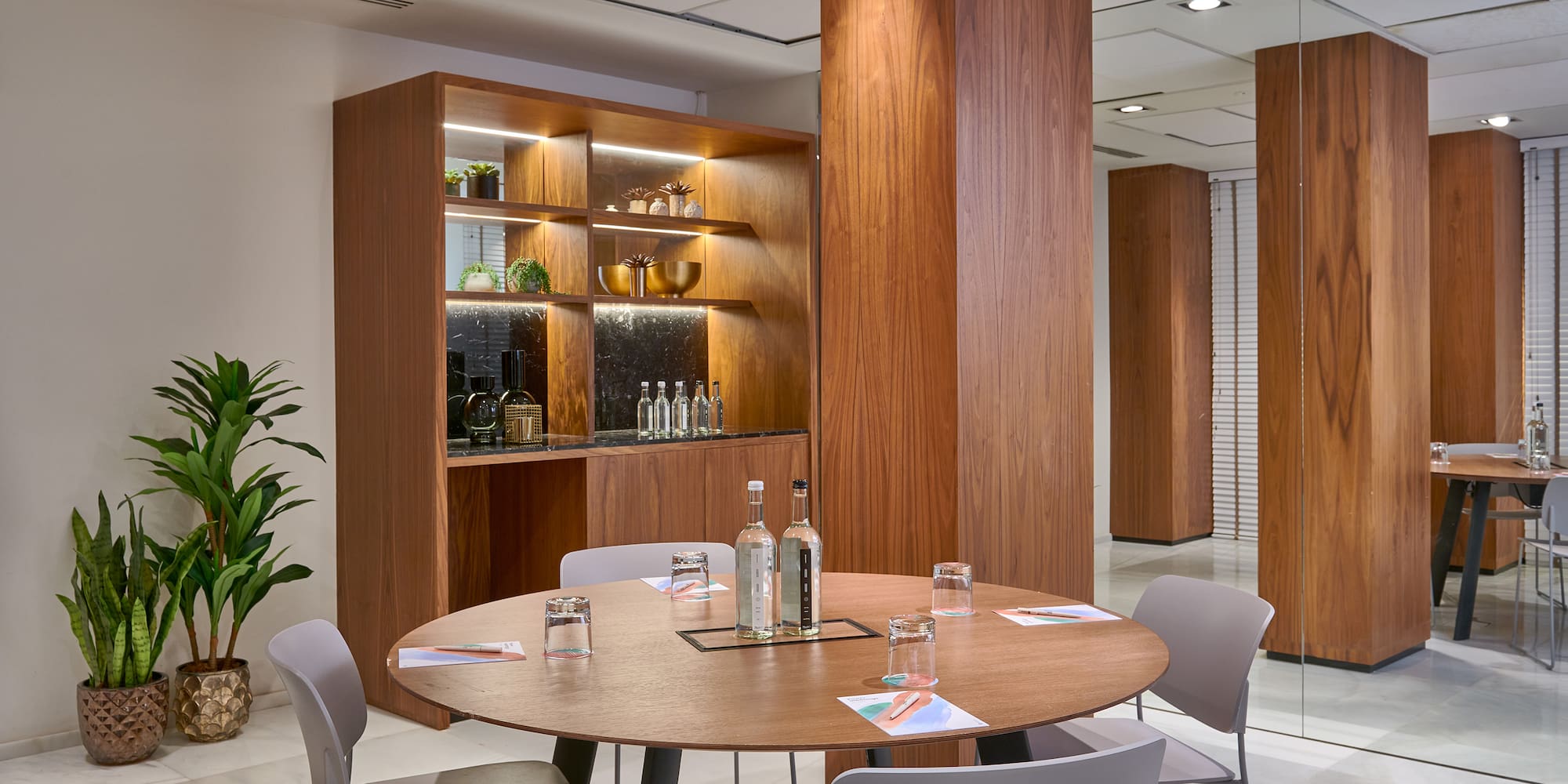 a room with a round table and chairs