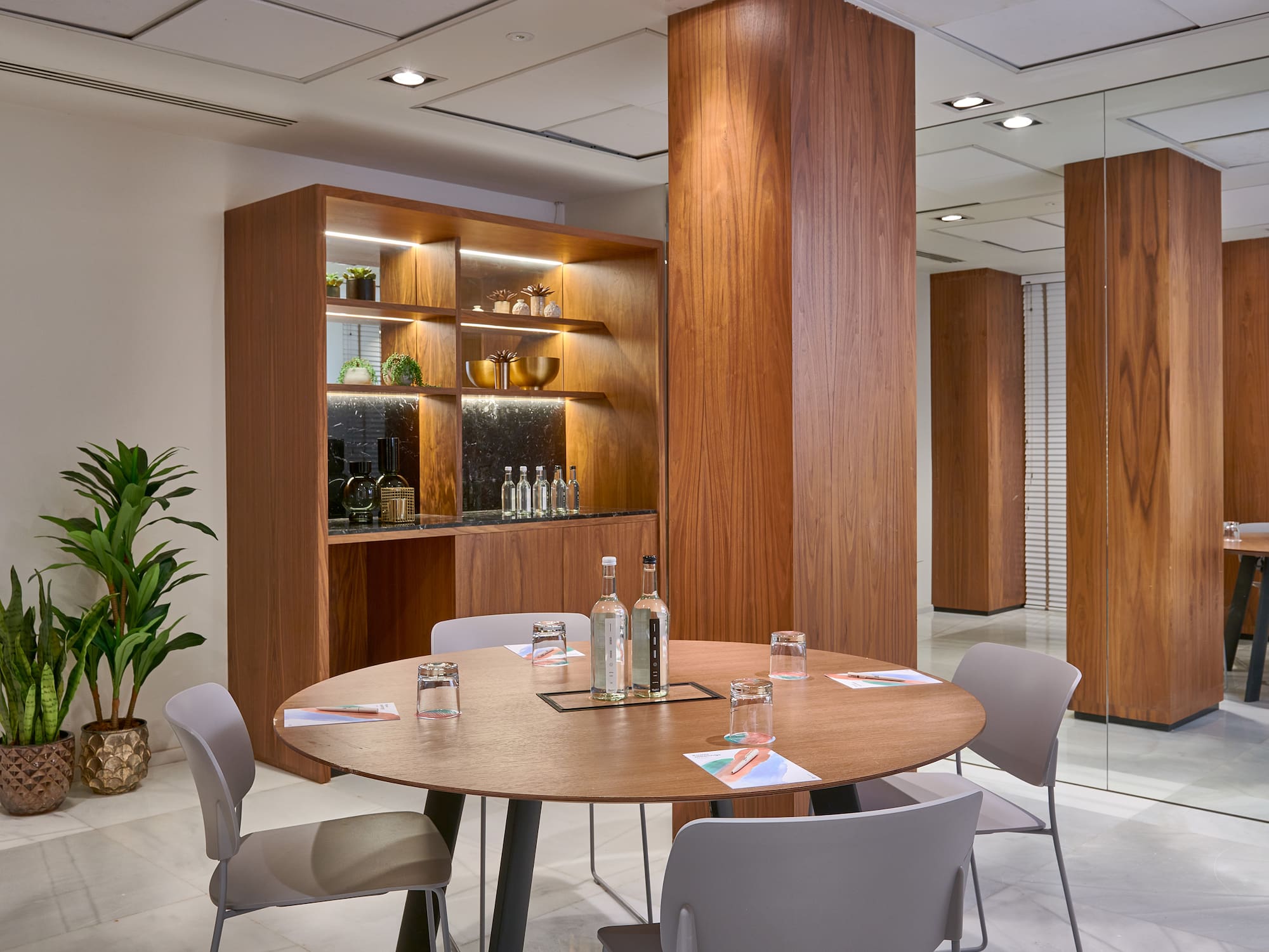 a room with a round table and chairs