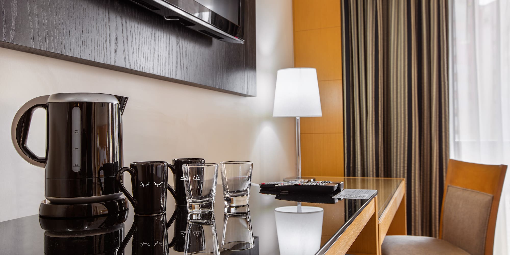 a table with glasses and a coffee maker on it