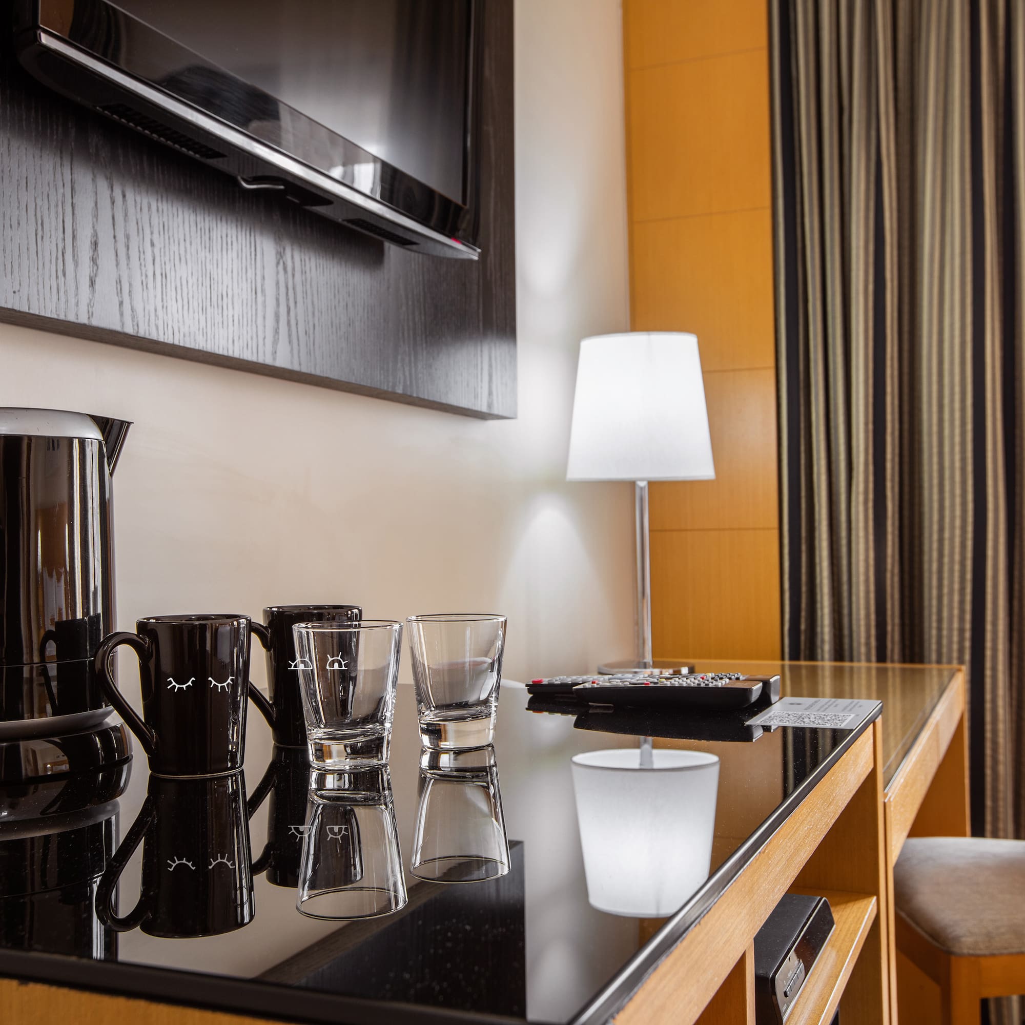 a table with glasses and a coffee maker on it