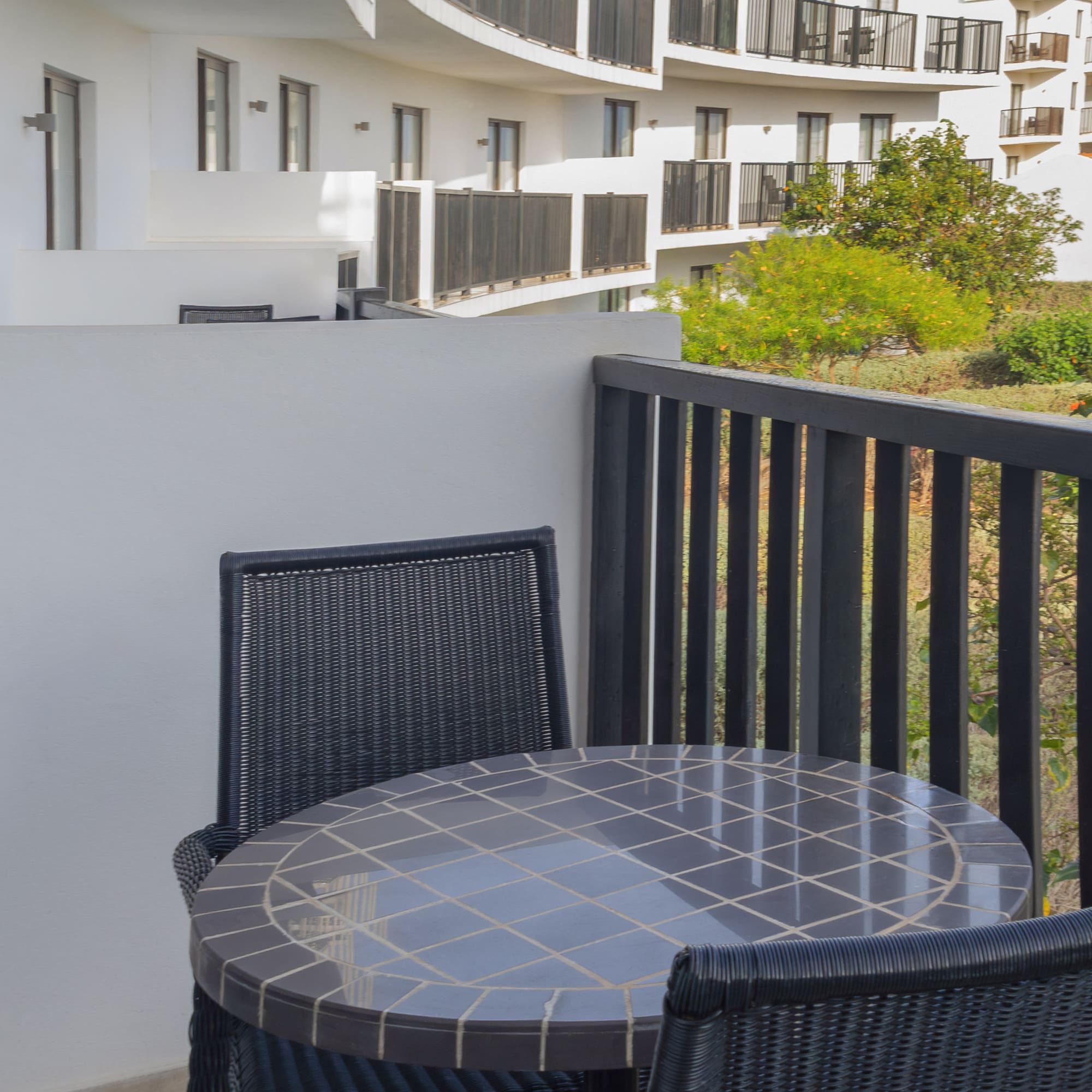 a table and chairs on a balcony