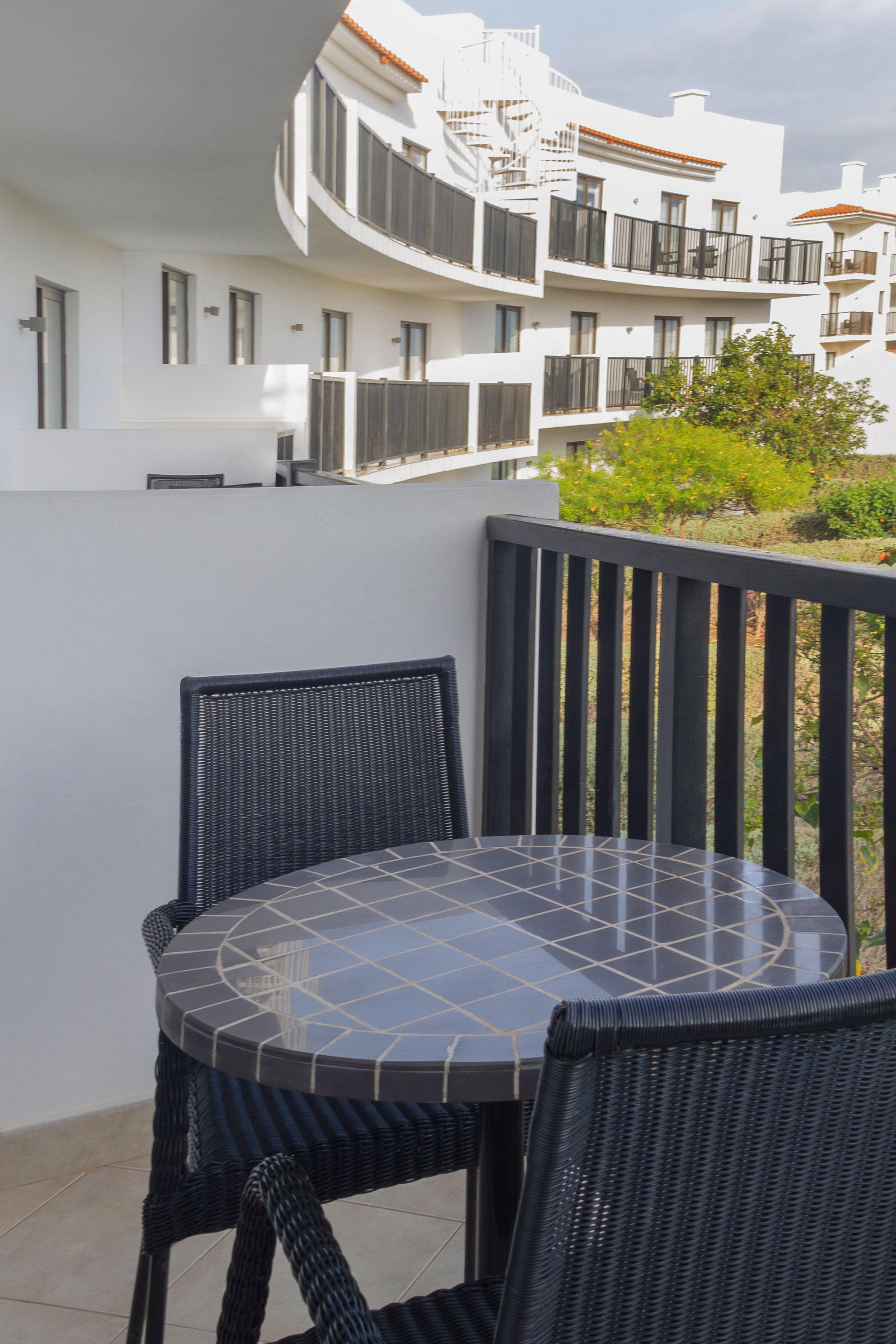 a table and chairs on a balcony