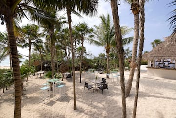 a group of tables and chairs on a beach