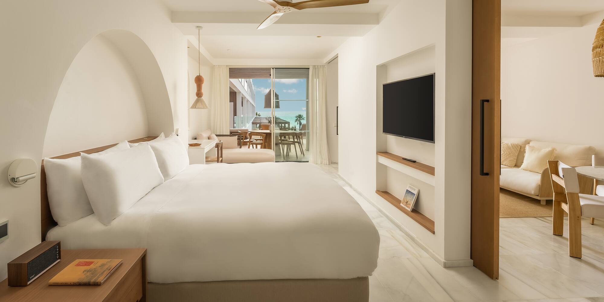 a room with a bed and a television