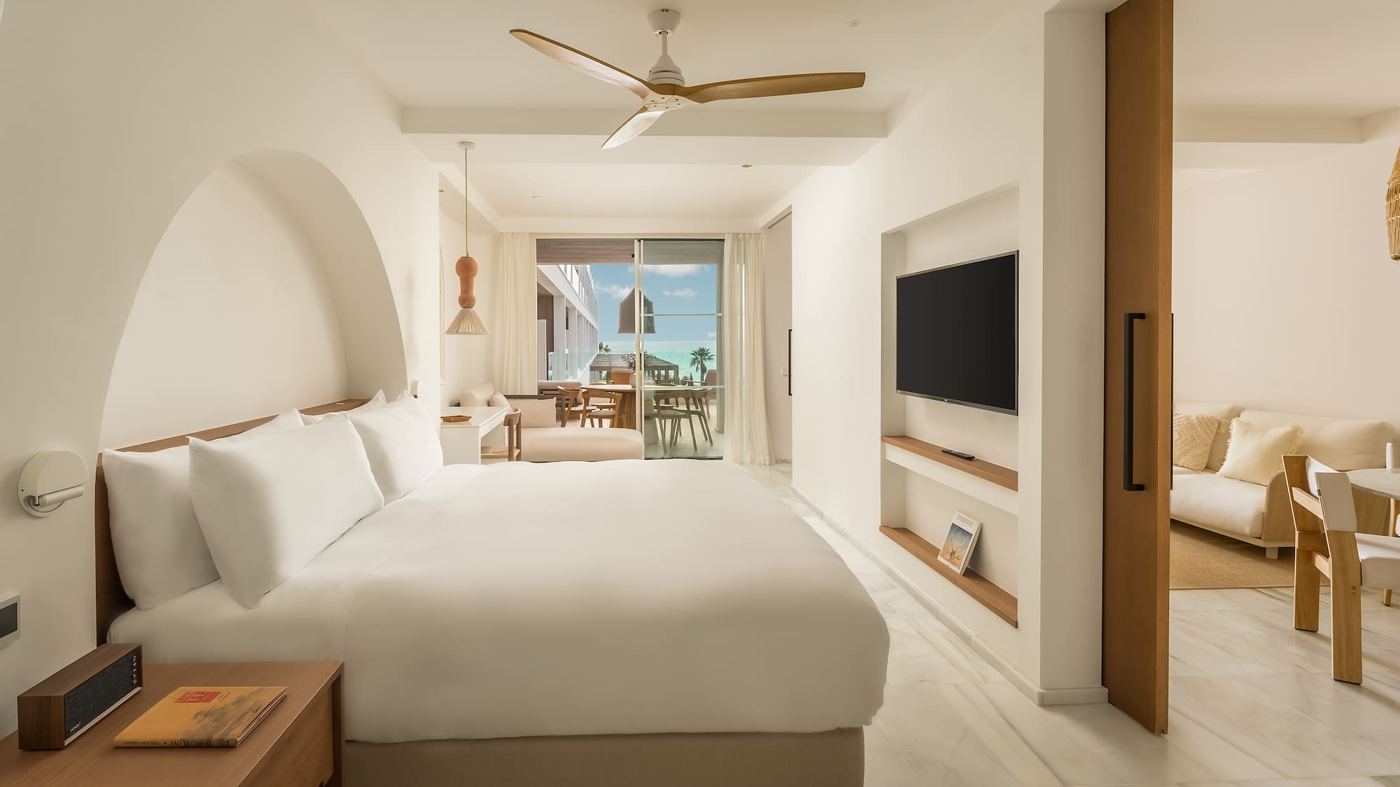 a room with a bed and a television