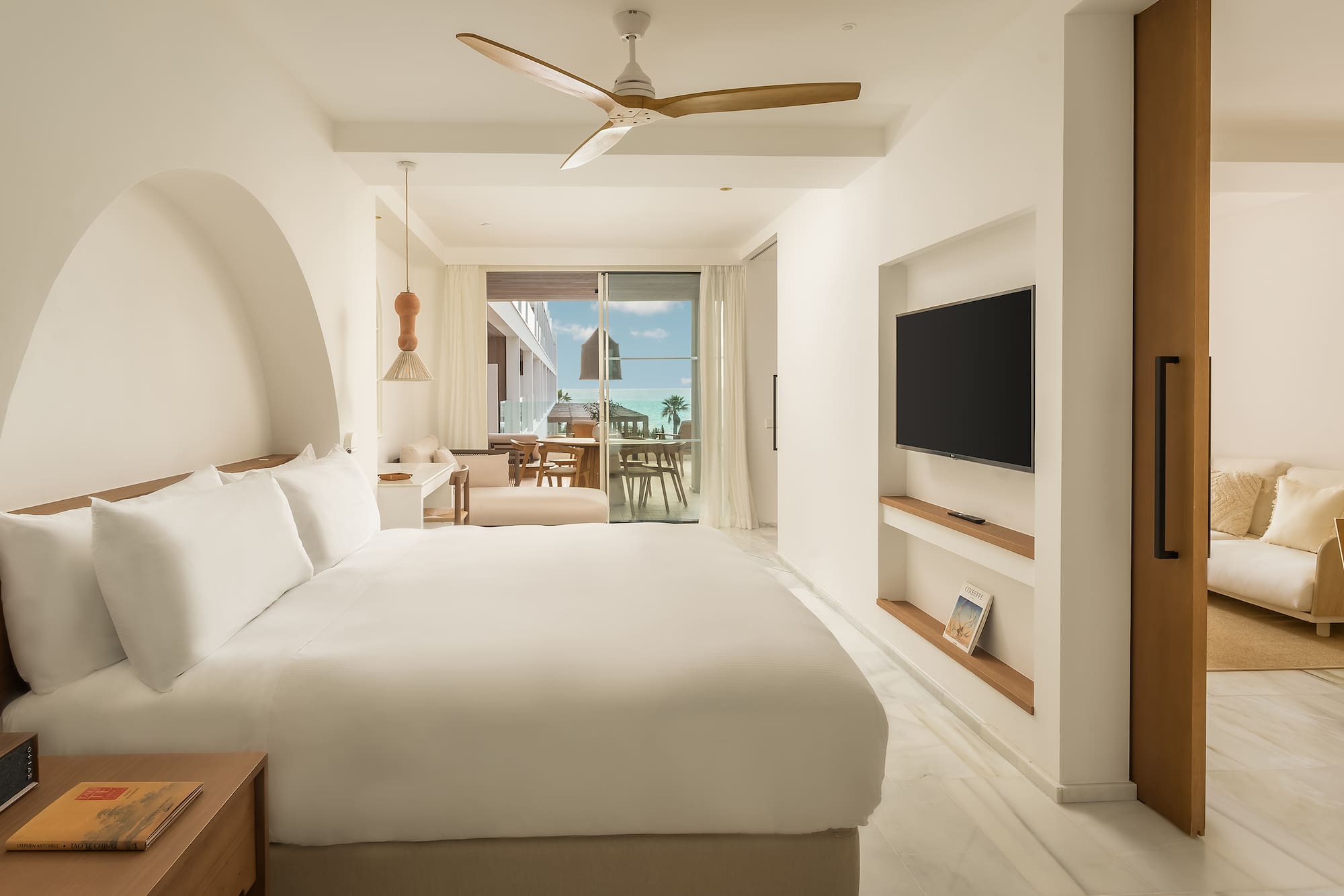 a room with a bed and a television