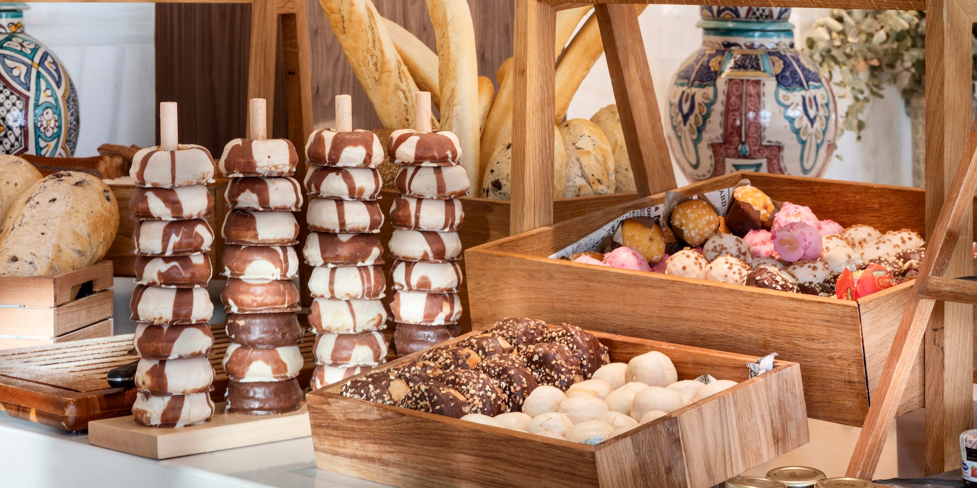 a variety of donuts in wooden containers