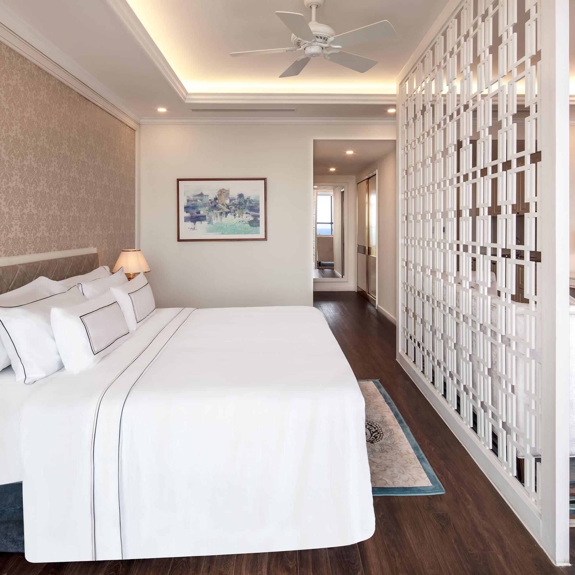 a room with a bed and a ceiling fan