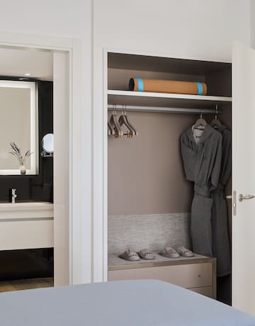 a closet with a towel and shoes
