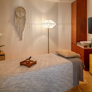 a room with a bed and a mirror