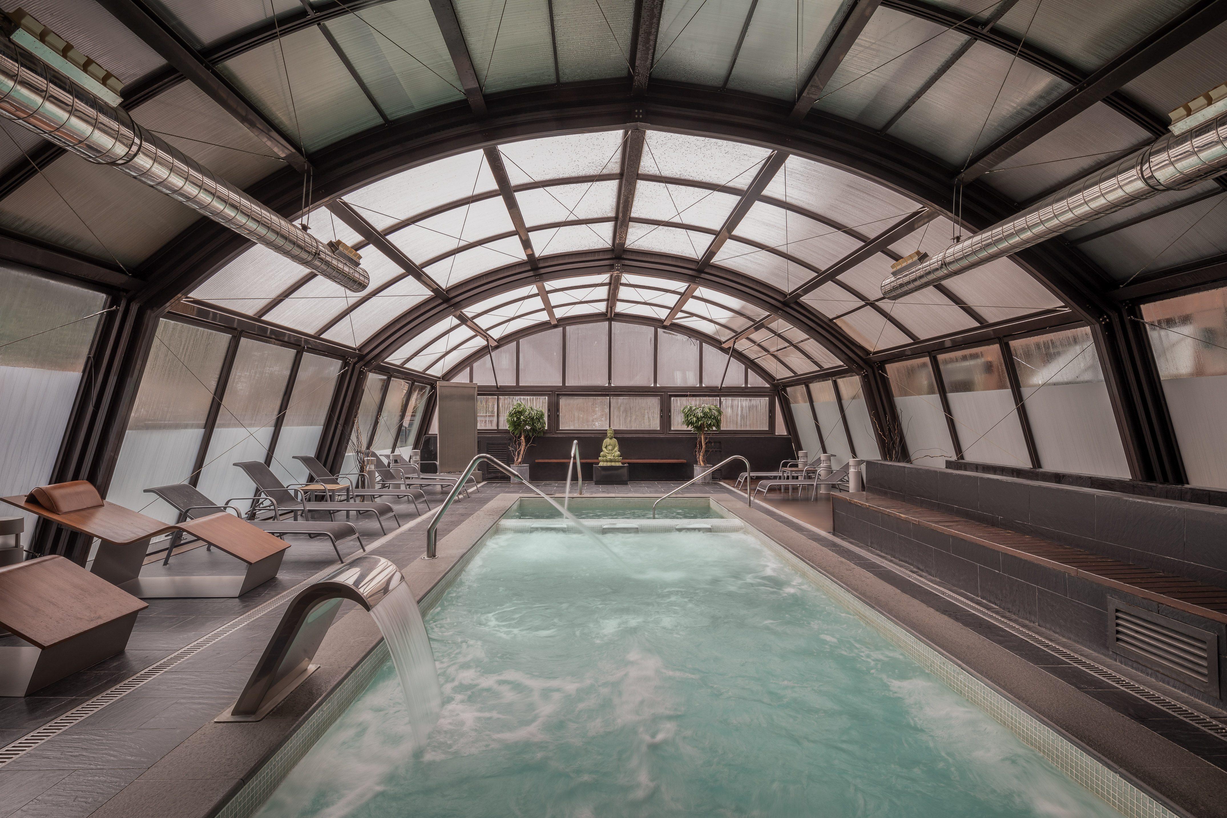 a indoor pool with a large tub and a large pool