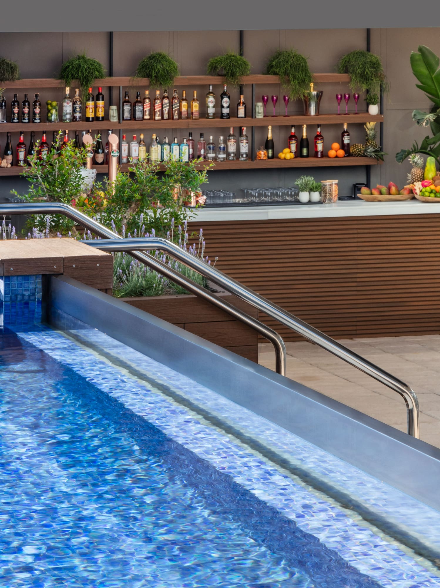a pool with a bar and shelves of drinks