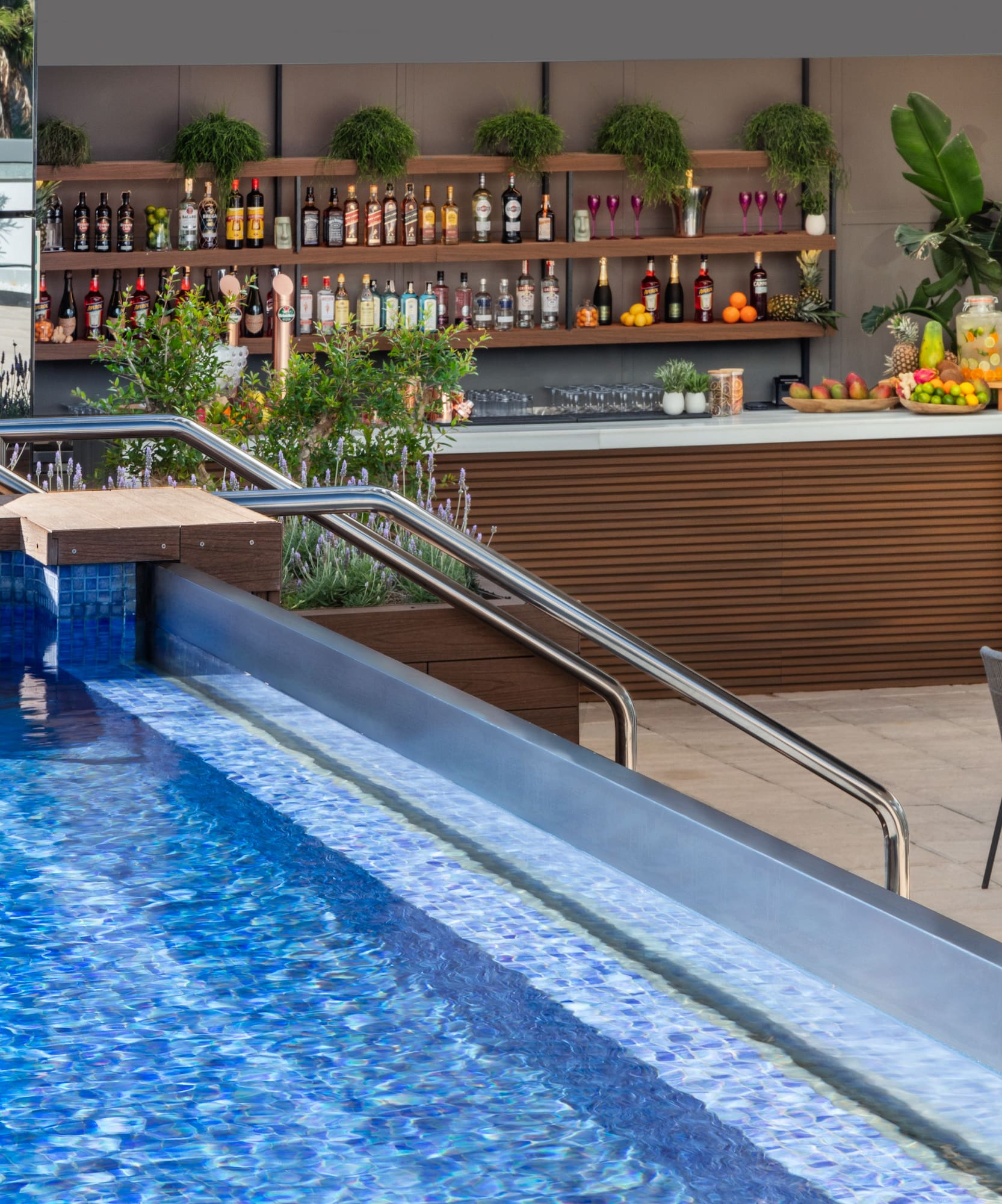 a pool with a bar and shelves of drinks