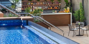 a pool with a bar and shelves of drinks