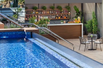 a pool with a bar and shelves of drinks