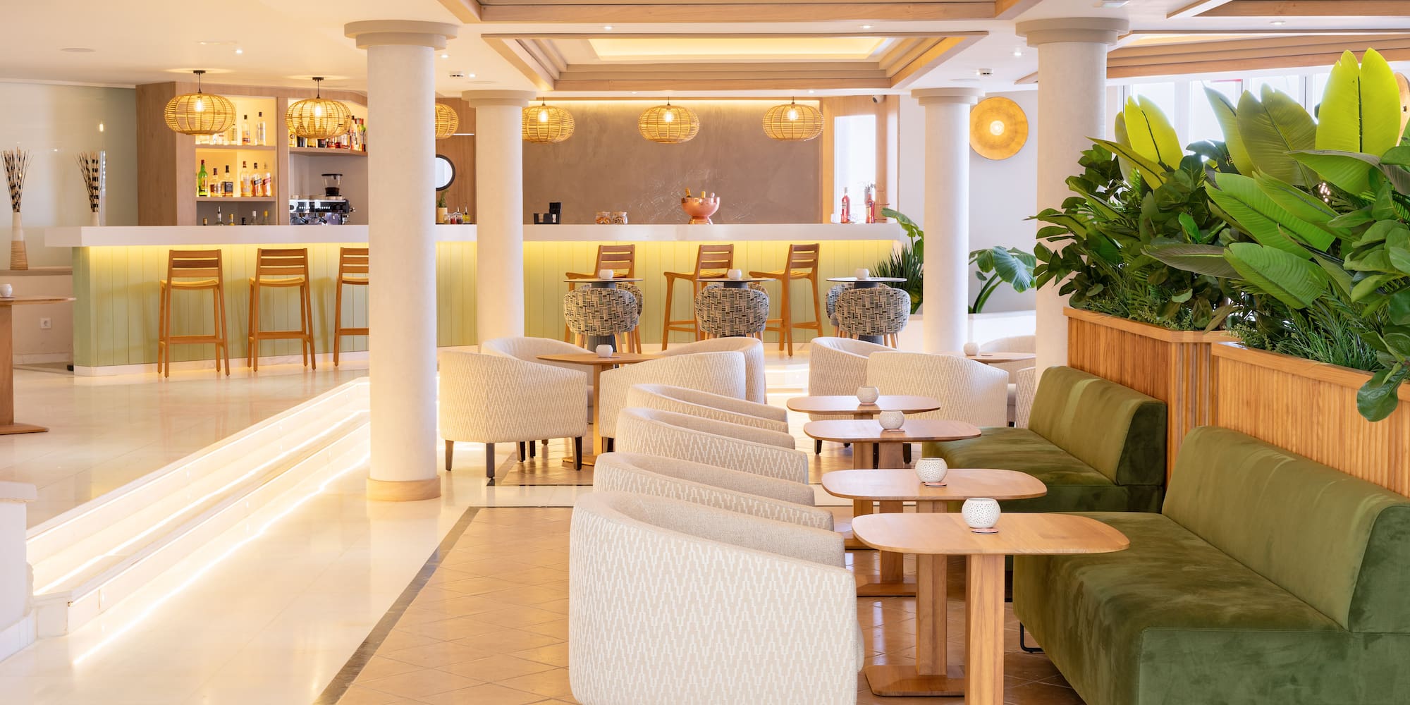 Modern hotel bar lounge with sleek design, various seating, and warm lighting.