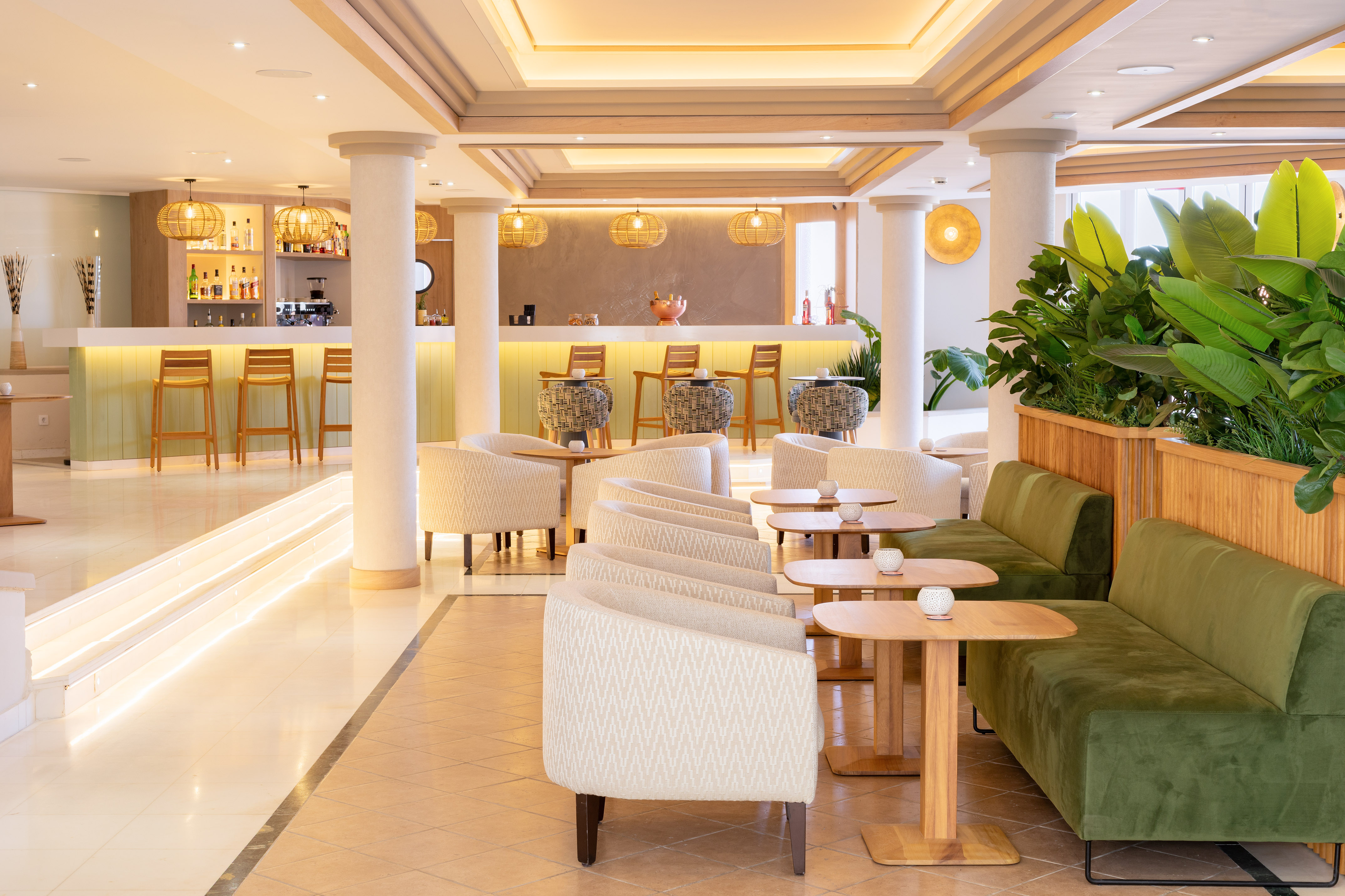 Modern hotel bar lounge with sleek design, various seating, and warm lighting.