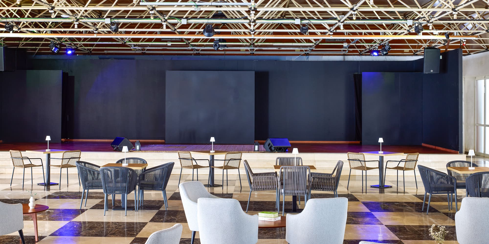 a room with a checkered floor and chairs