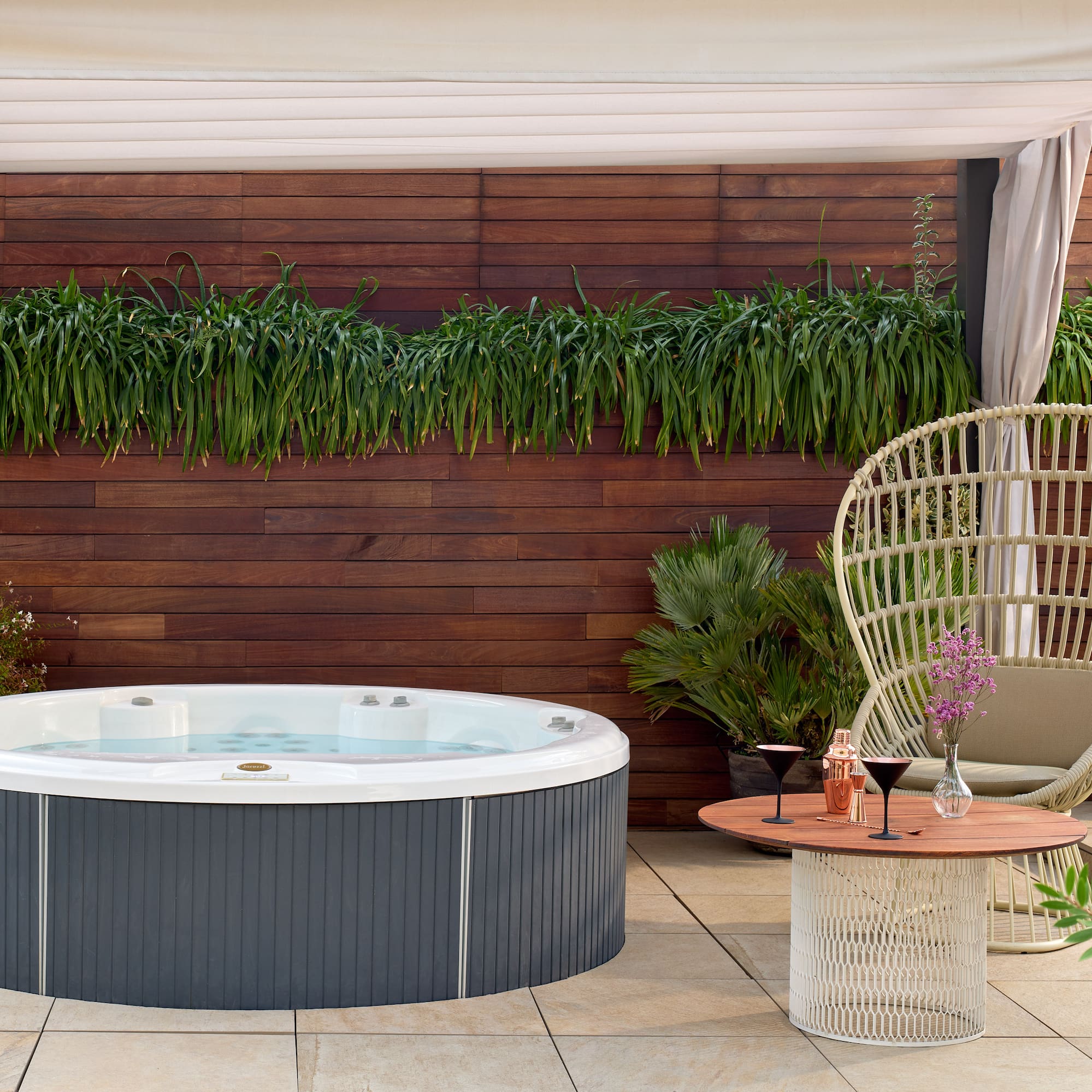a hot tub and a chair on a patio