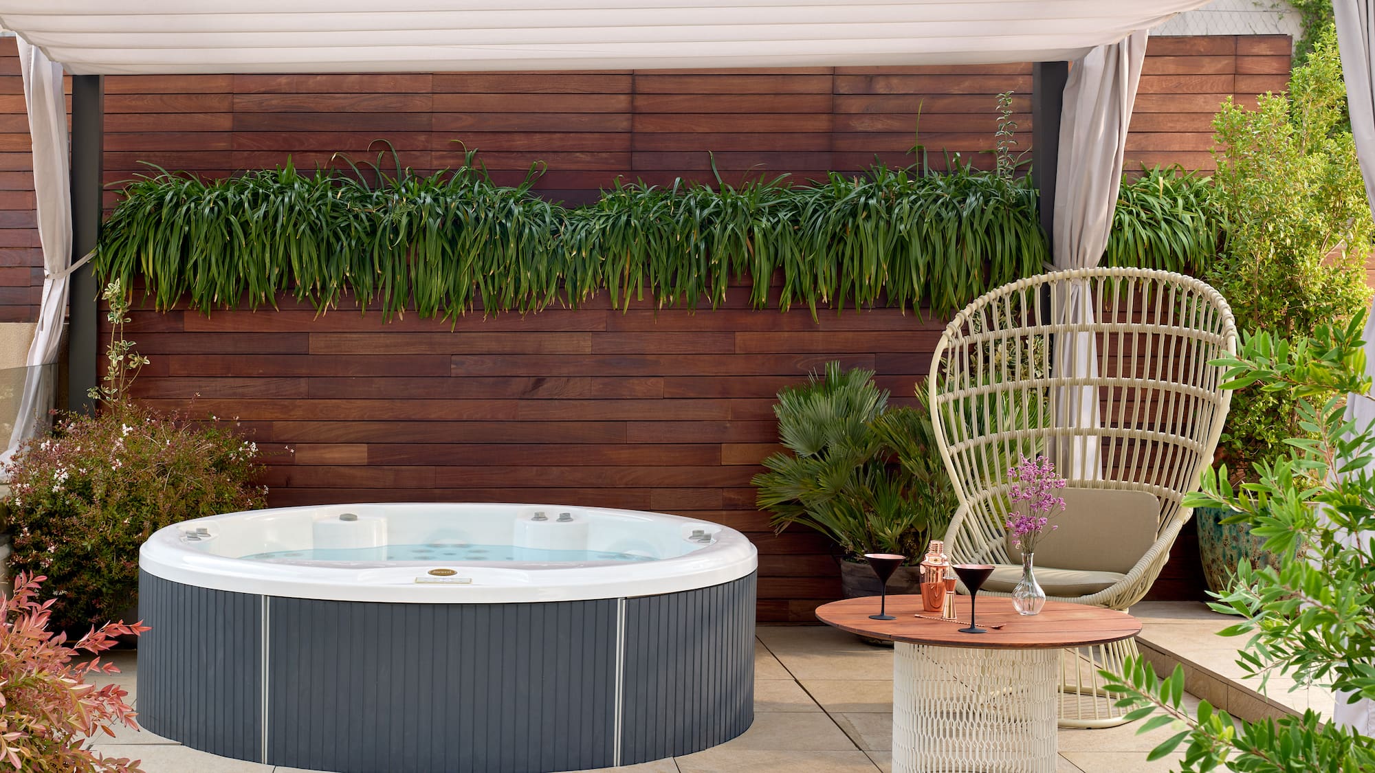 a hot tub and a chair on a patio