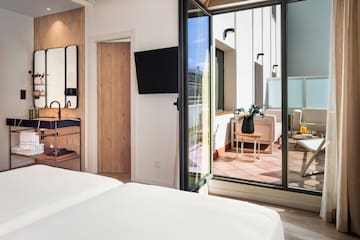a room with a glass door and a bed