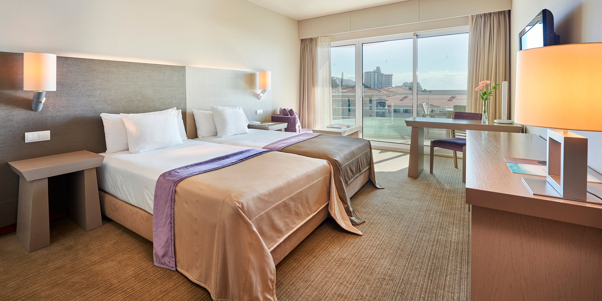 a hotel room with two beds and a table