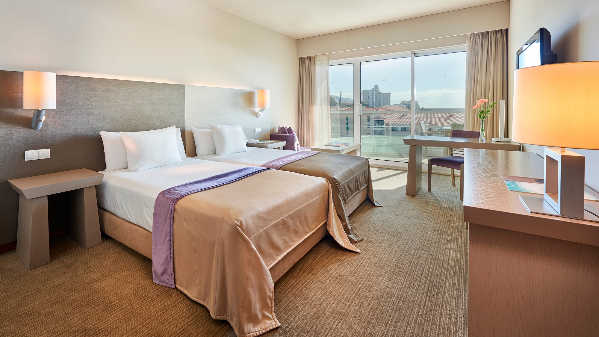 a hotel room with two beds and a table