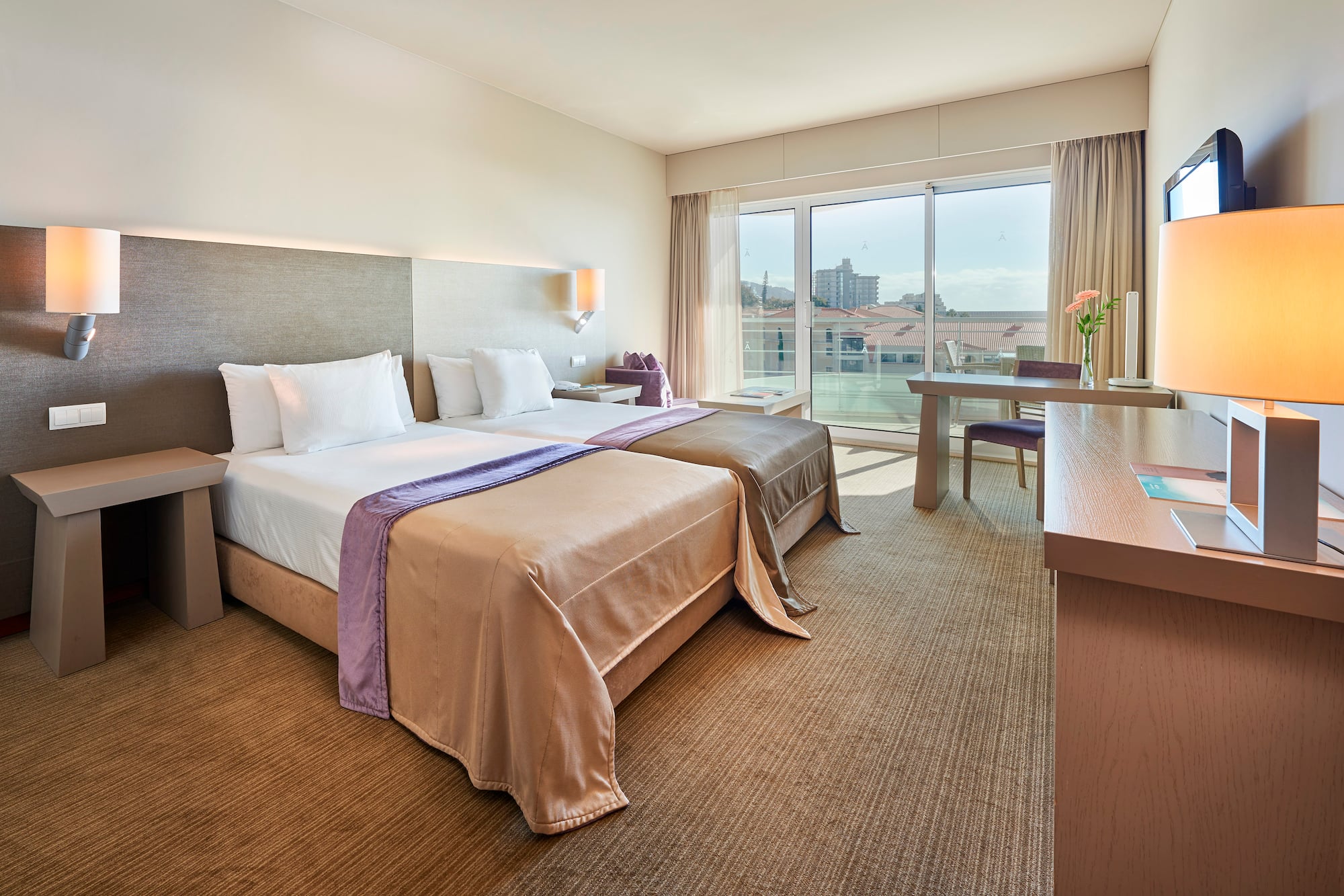 a hotel room with two beds and a table