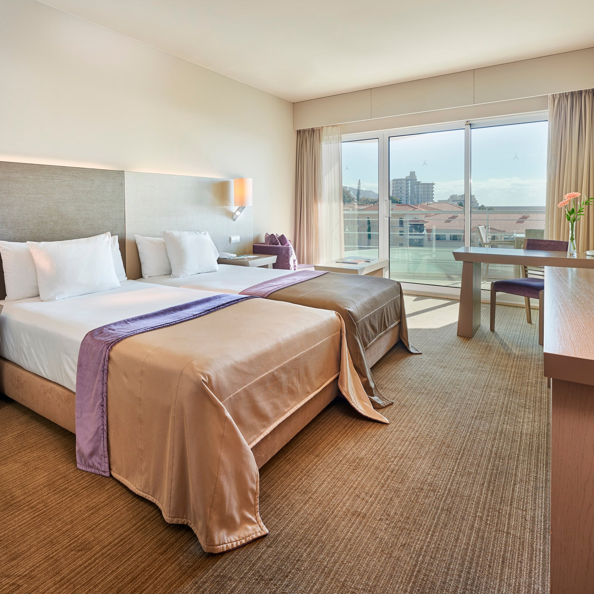 a hotel room with two beds and a table