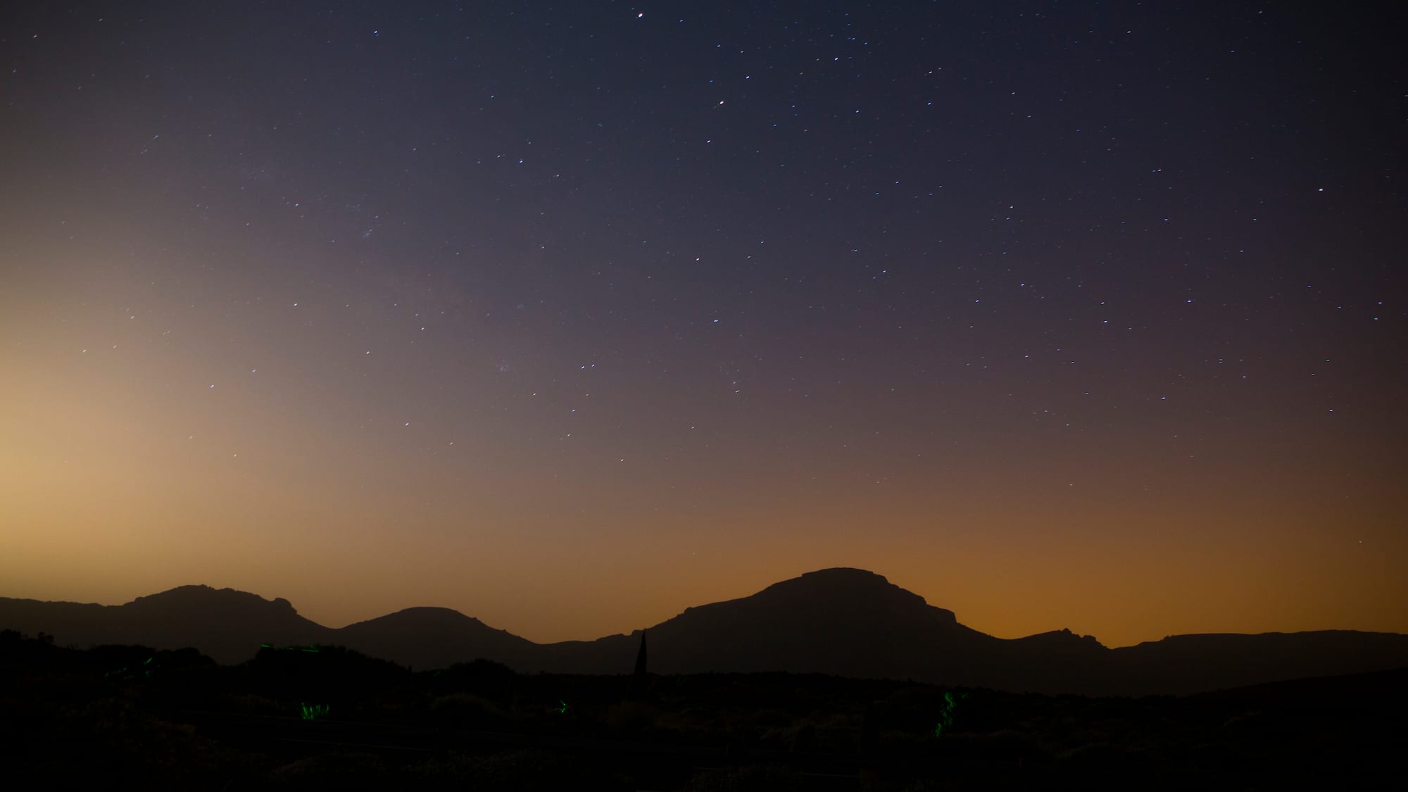 a starry sky over mountains