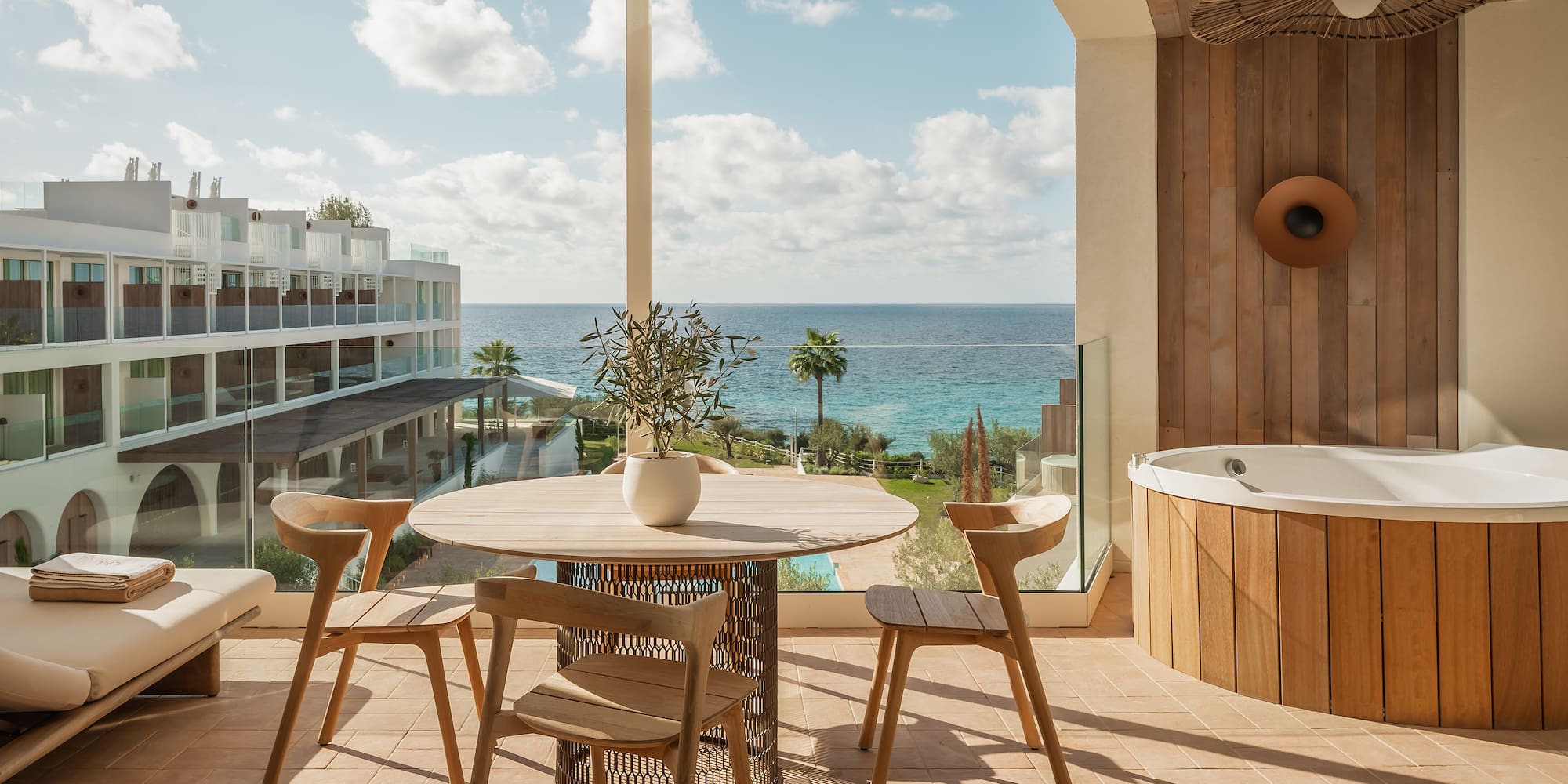 a patio with a hot tub and a table and chairs
