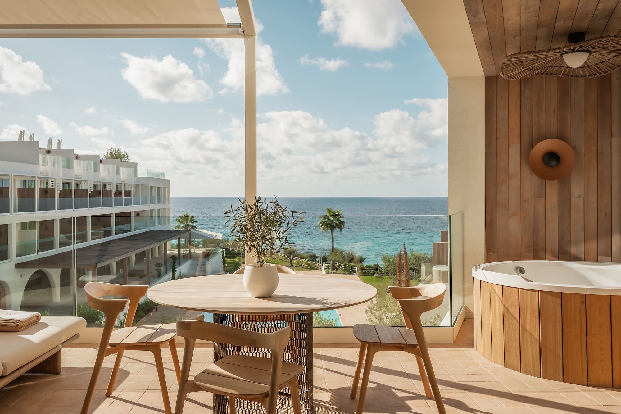 a patio with a hot tub and a table and chairs
