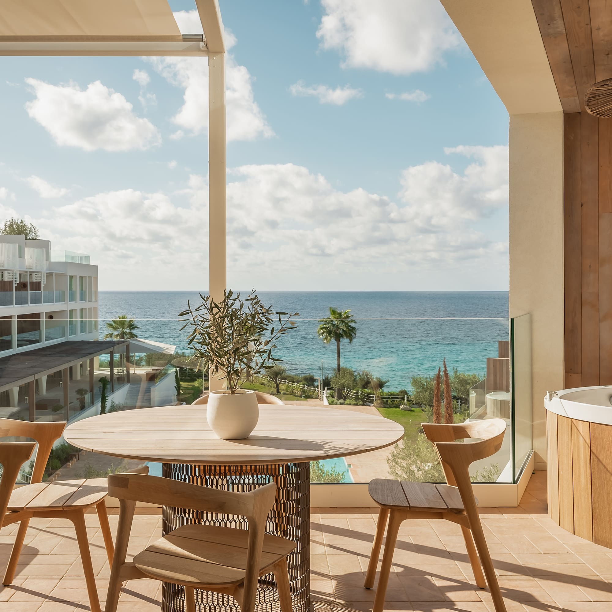 a patio with a hot tub and a table and chairs
