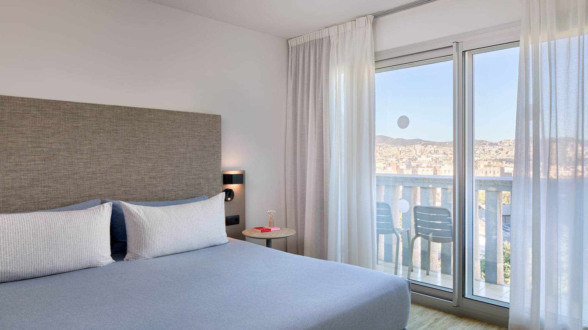 a bedroom with a bed and glass doors