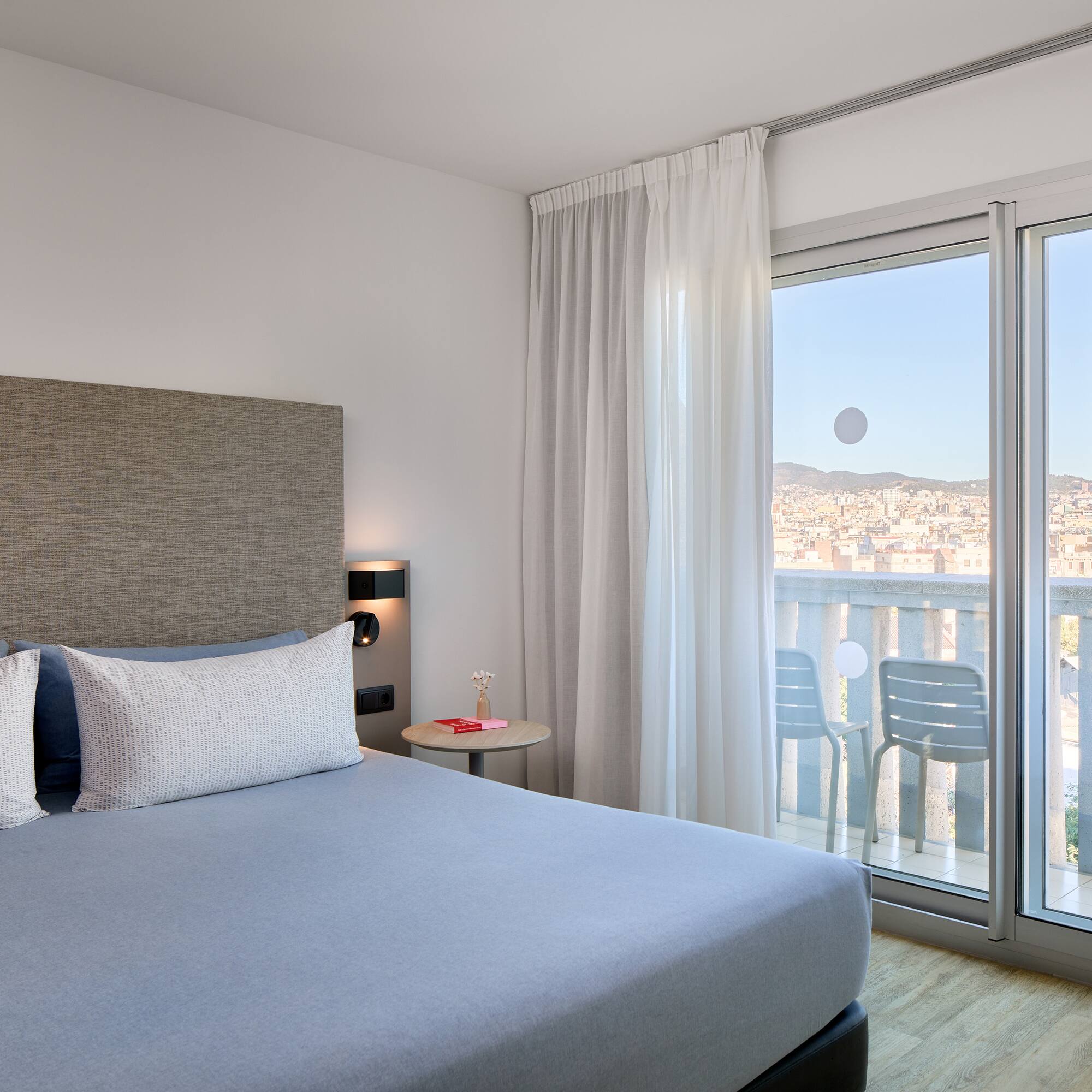 a bedroom with a bed and glass doors