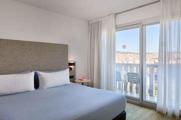 a bedroom with a bed and glass doors