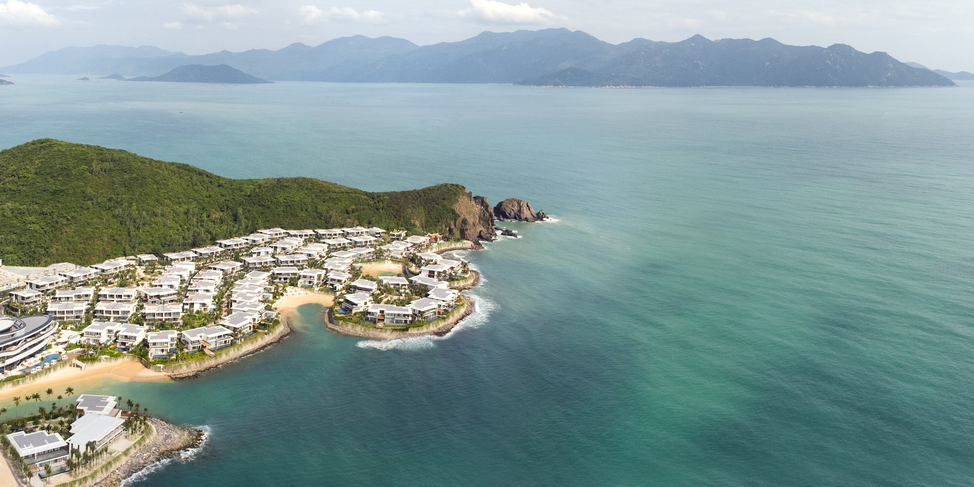 a group of houses on a rocky island surrounded by water