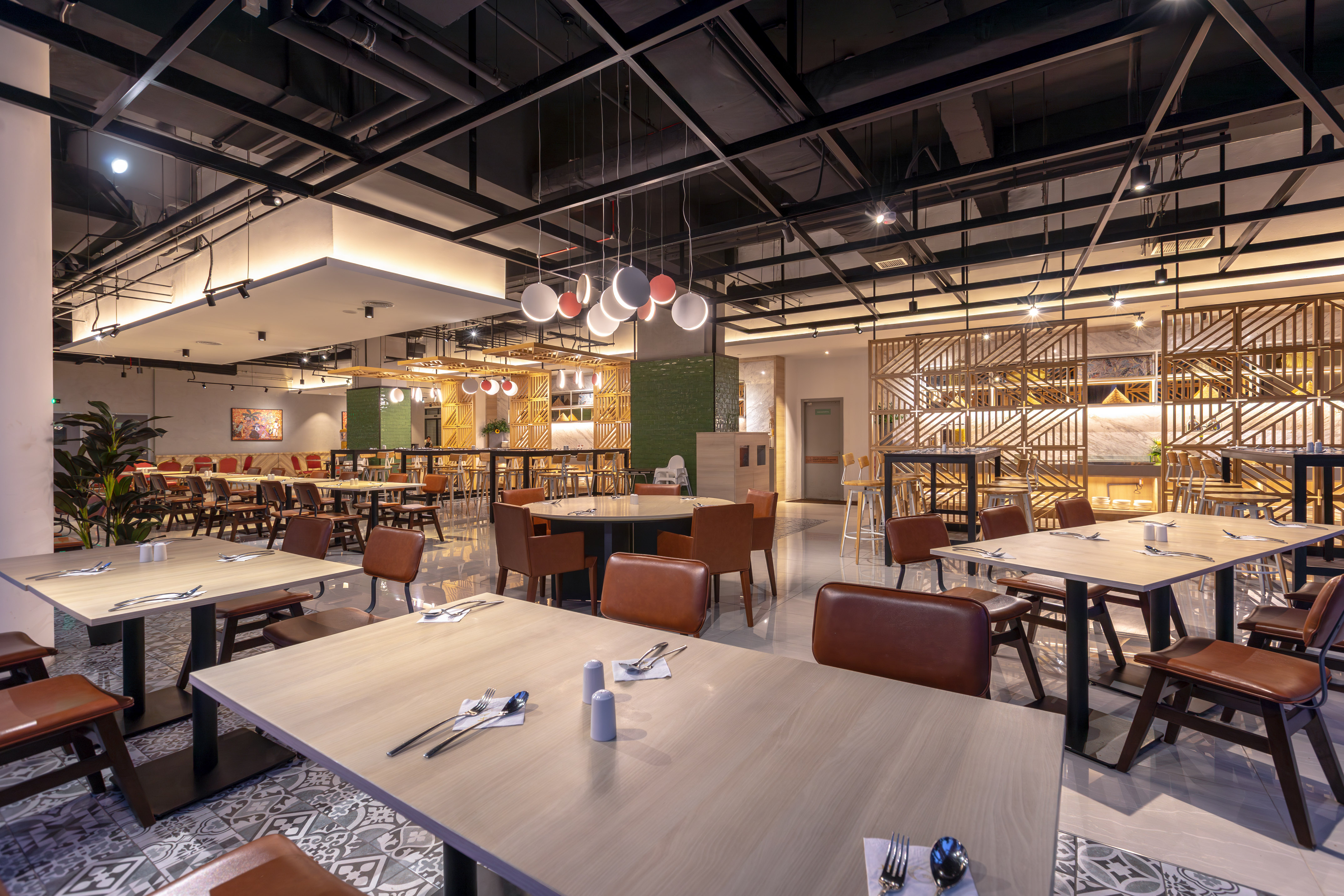 Modern restaurant interior with brown leather chairs and light wooden tables.