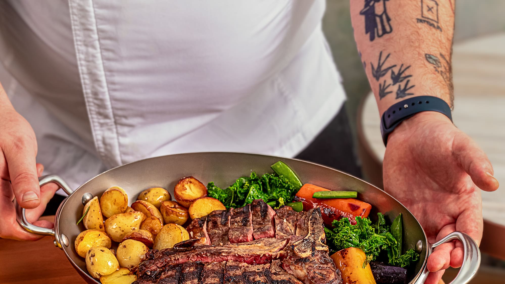 a person holding a pan of food