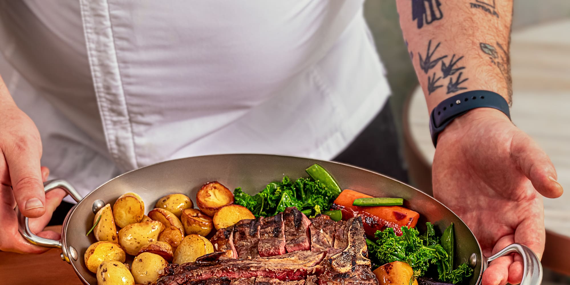 a person holding a pan of food