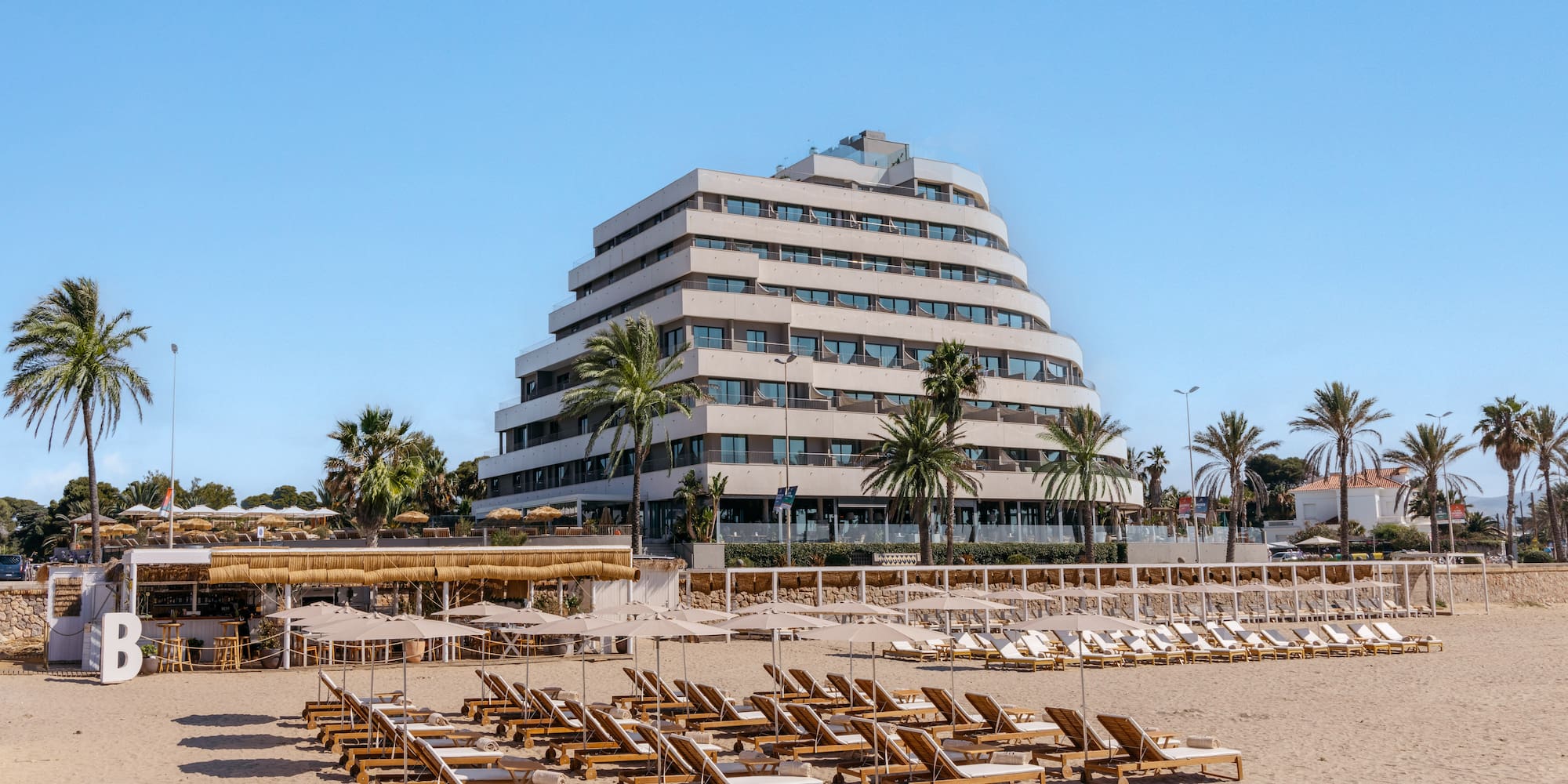a beach with lounge chairs and umbrellas