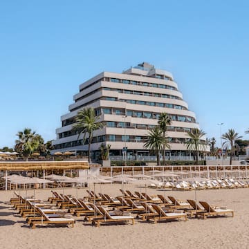 a beach with lounge chairs and umbrellas