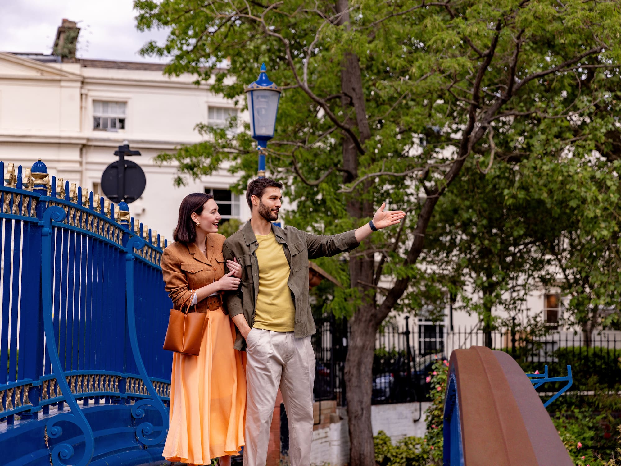 a man and woman standing on a bridge