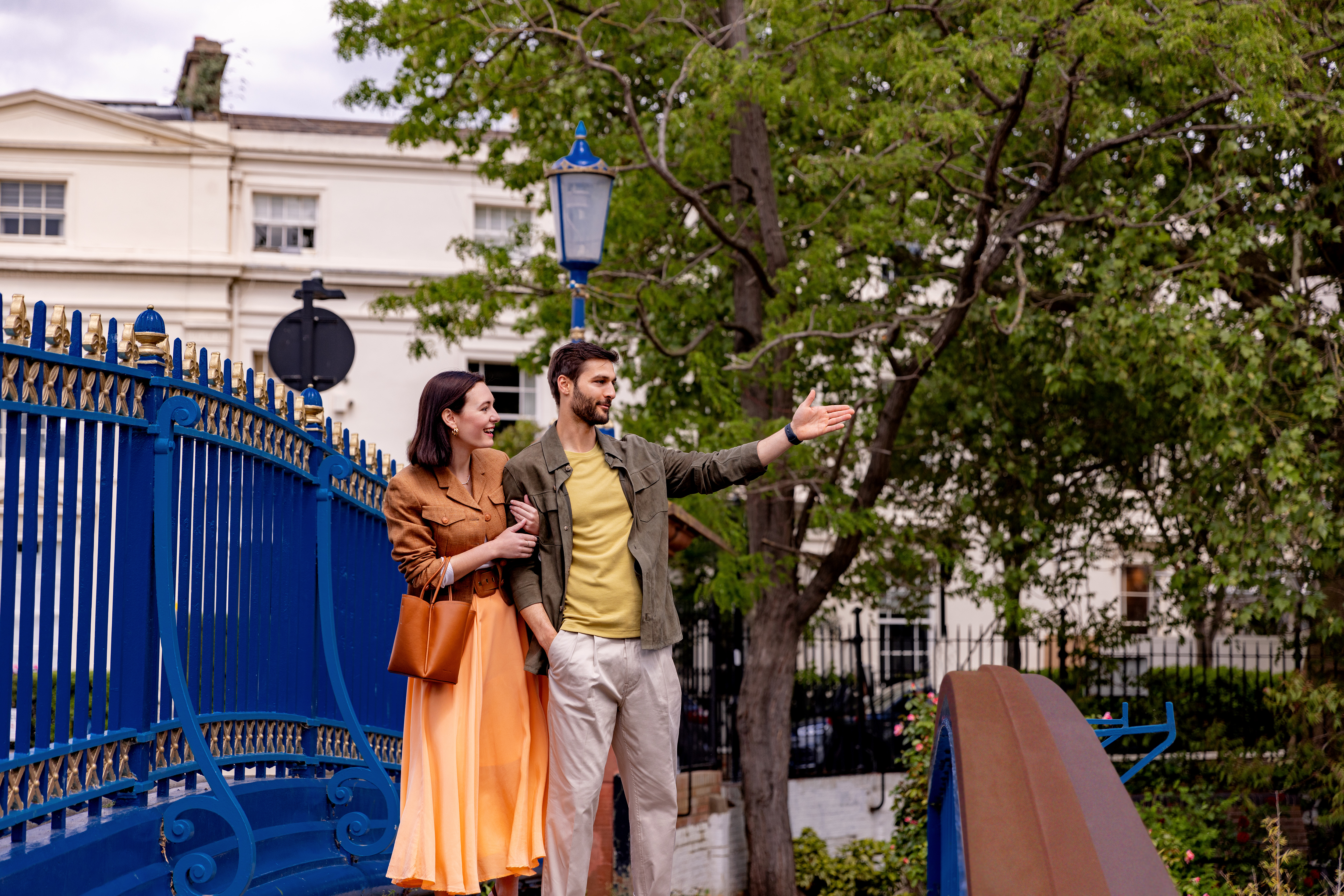 a man and woman standing on a bridge