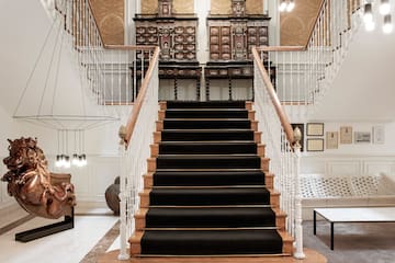 a staircase with black carpet and white railings