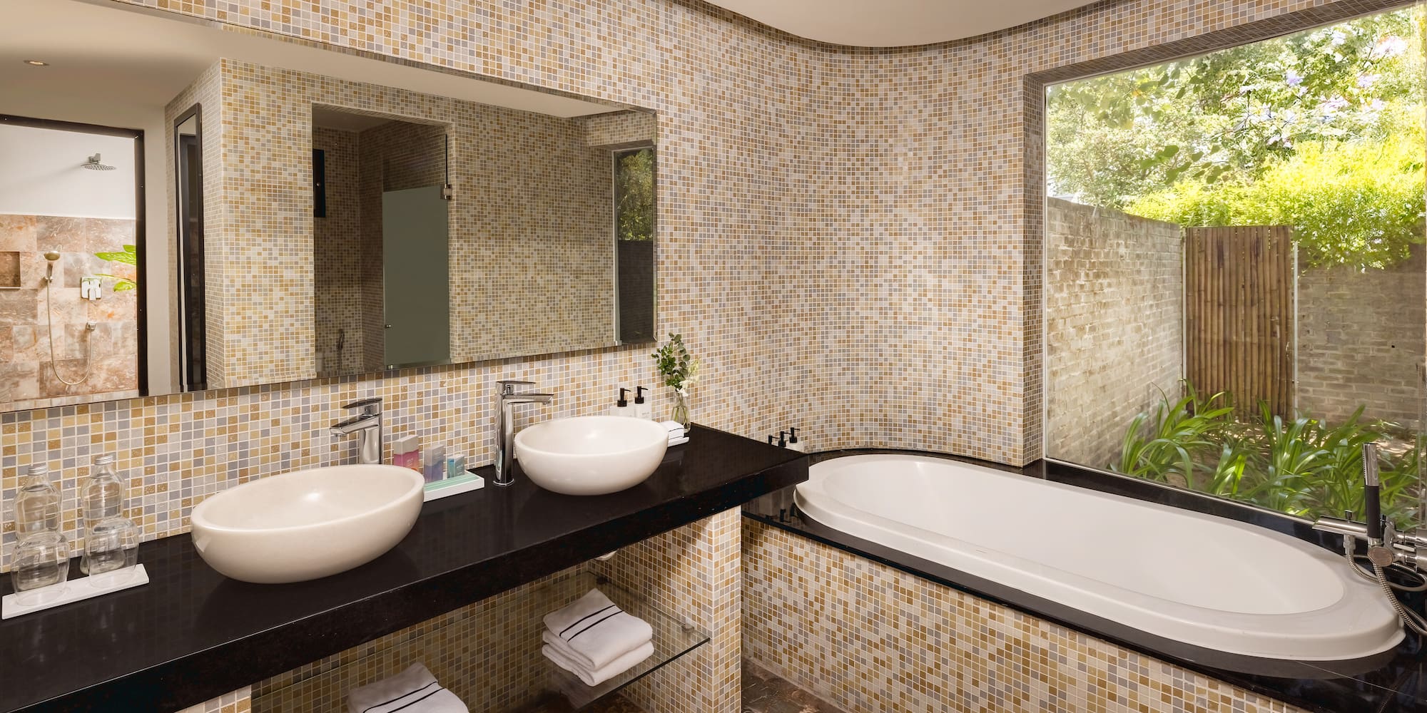 a bathroom with a tub and sinks