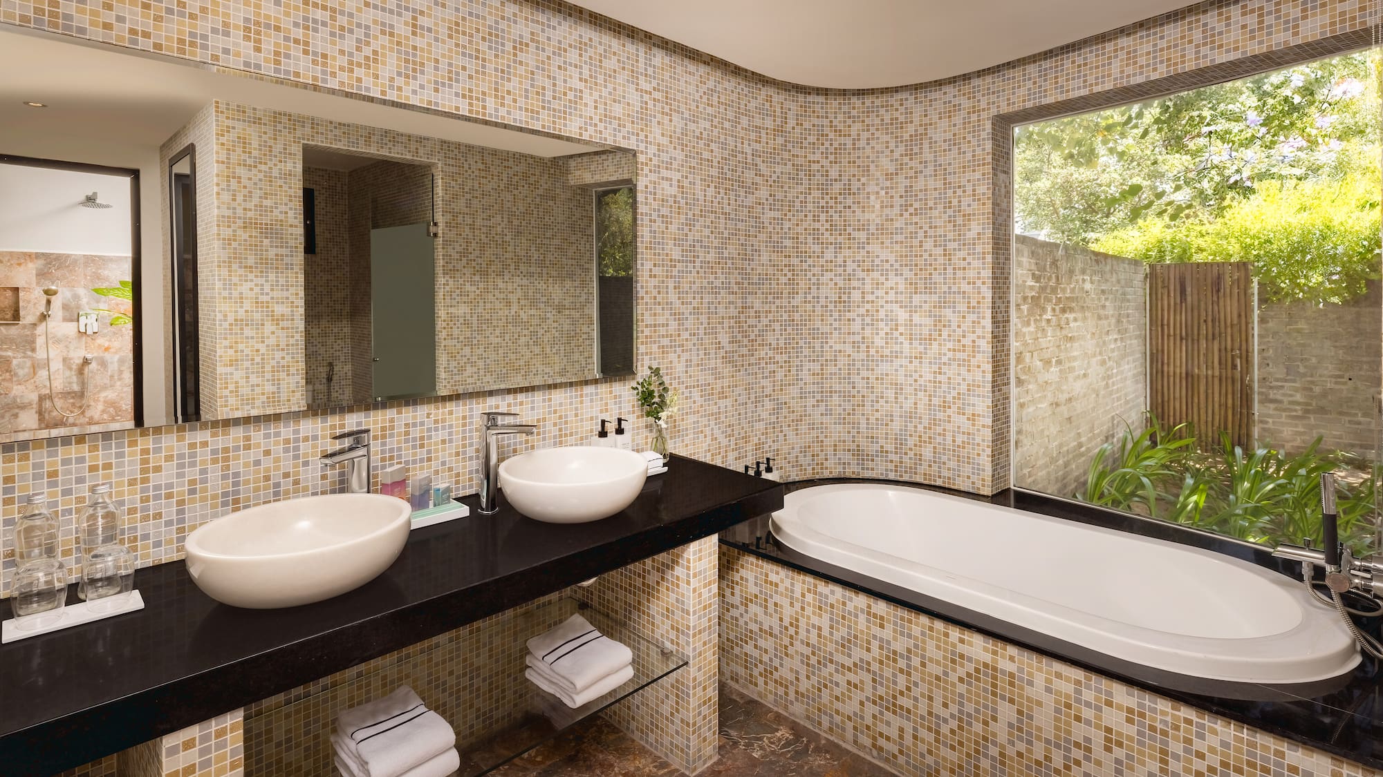 a bathroom with a tub and sinks