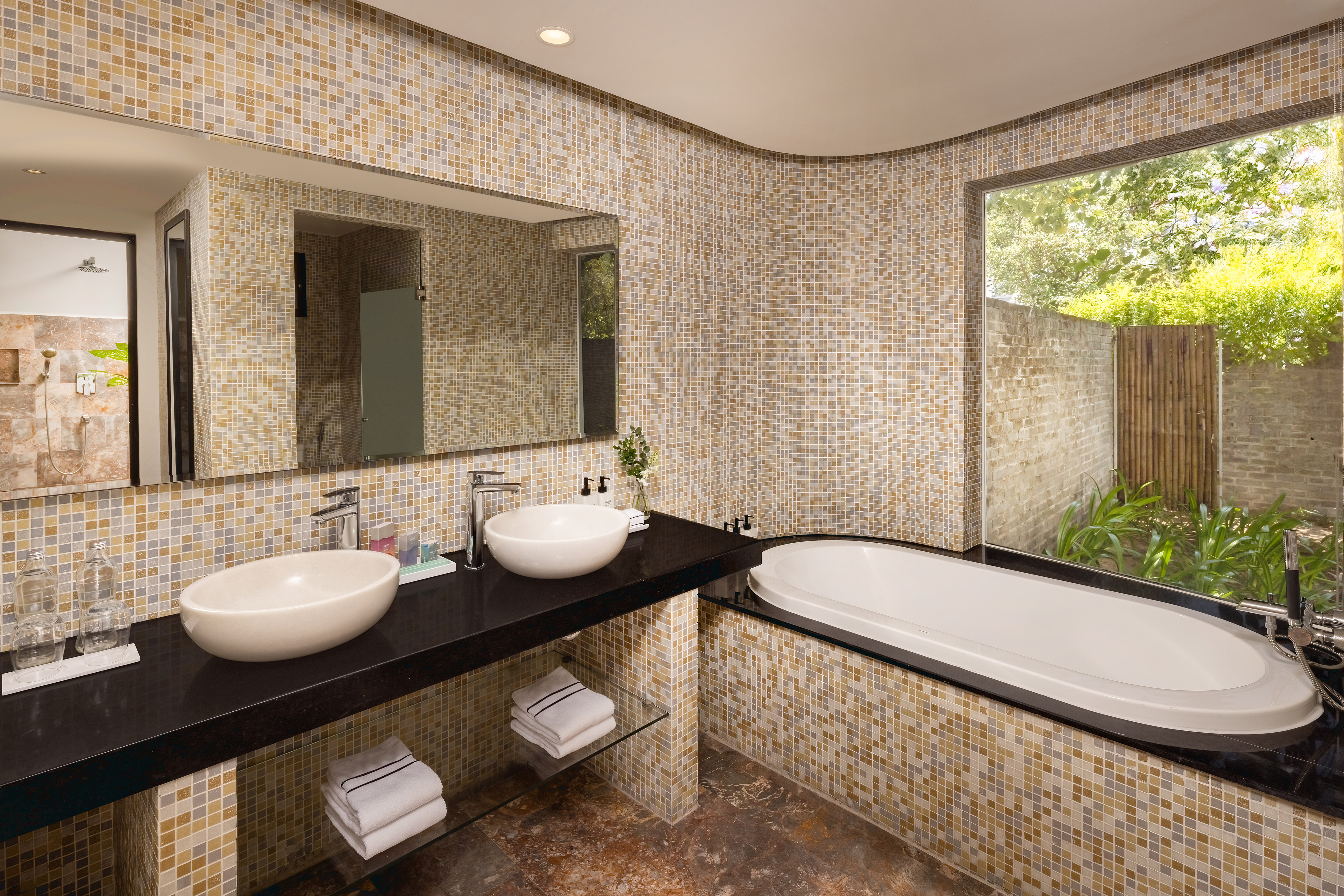 a bathroom with a tub and sinks