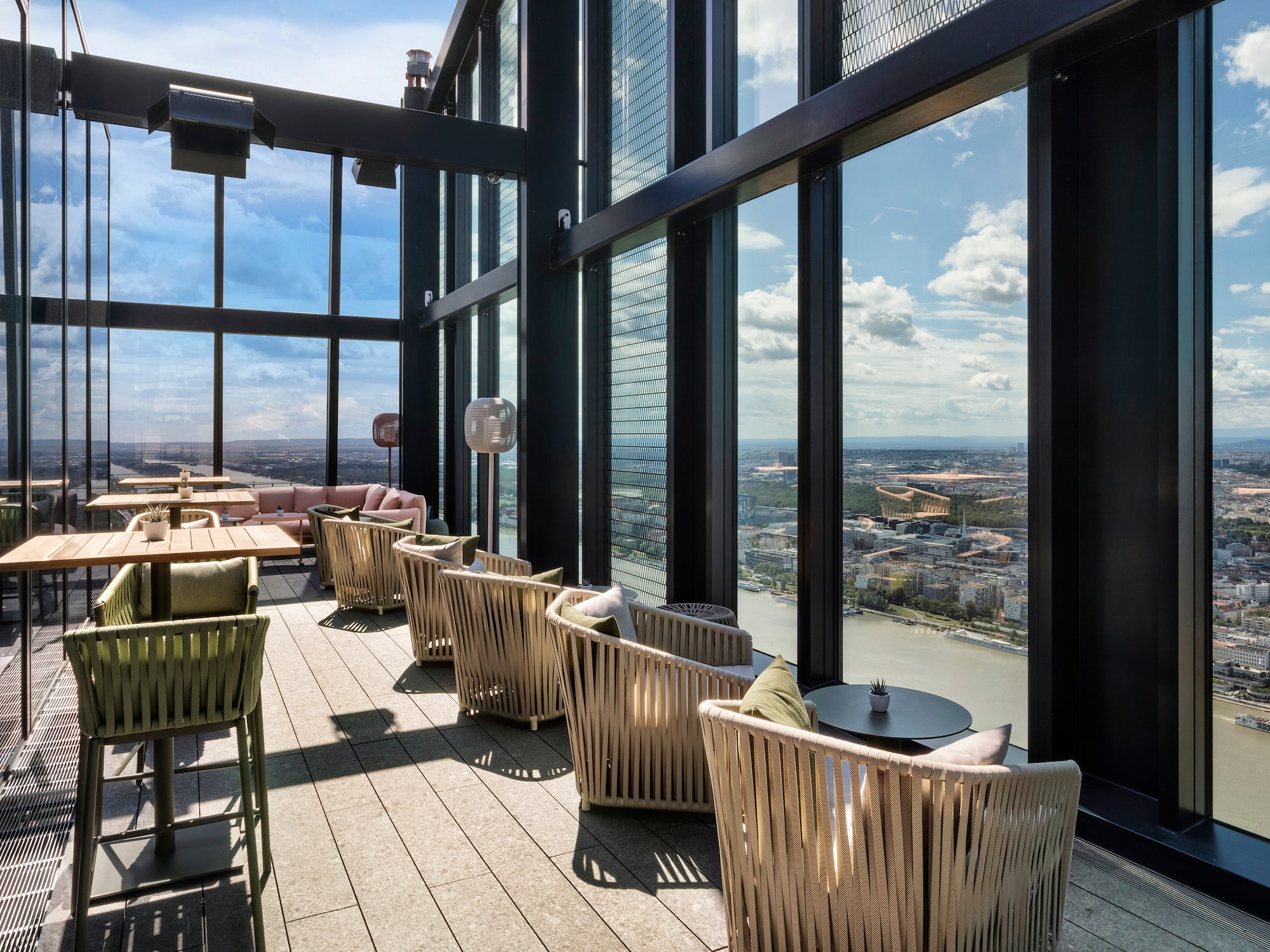 a room with chairs and tables and a view of a city