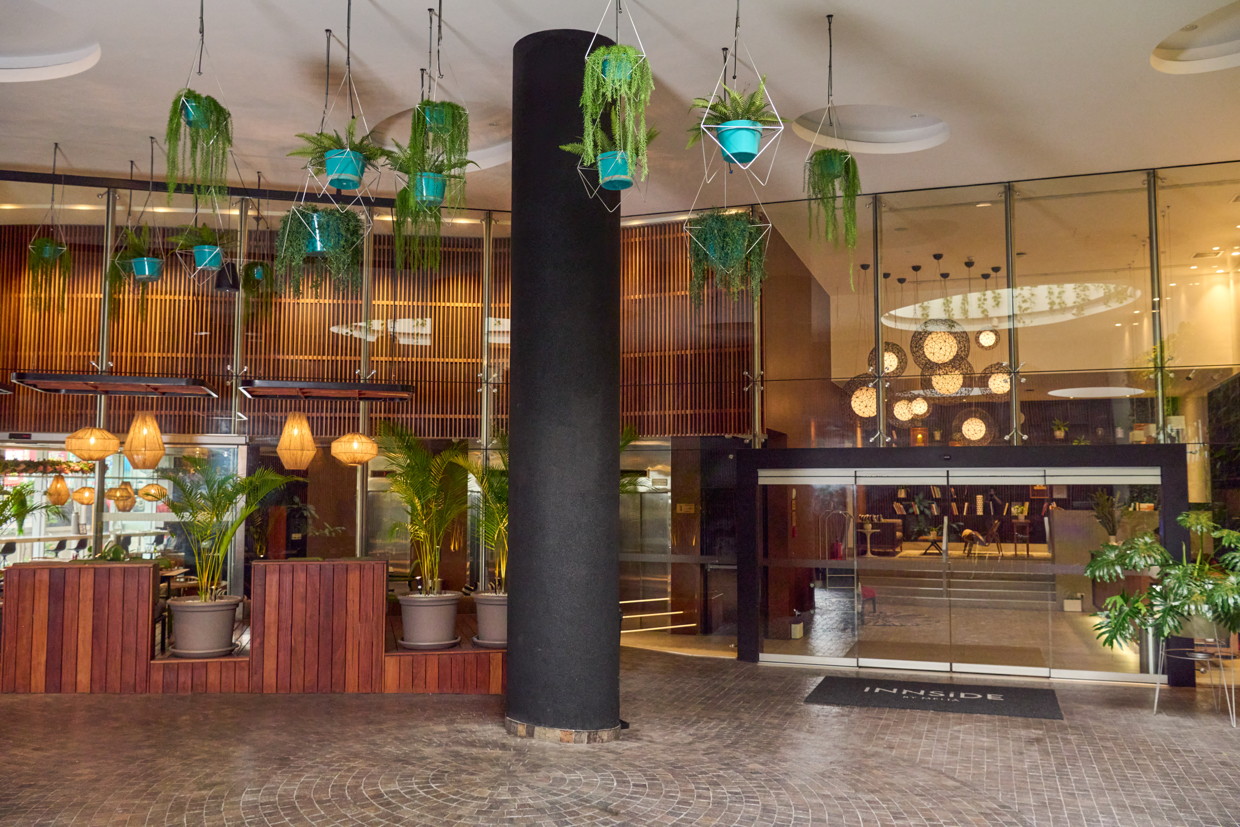 a building with plants from the ceiling